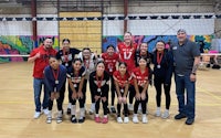 a group of volleyball players posing for a picture