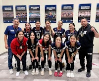 a group of girls posing for a picture with their medals