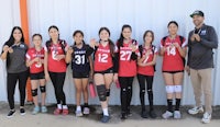 a group of volleyball players posing for a picture