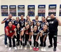 a group of girls posing for a picture with their medals